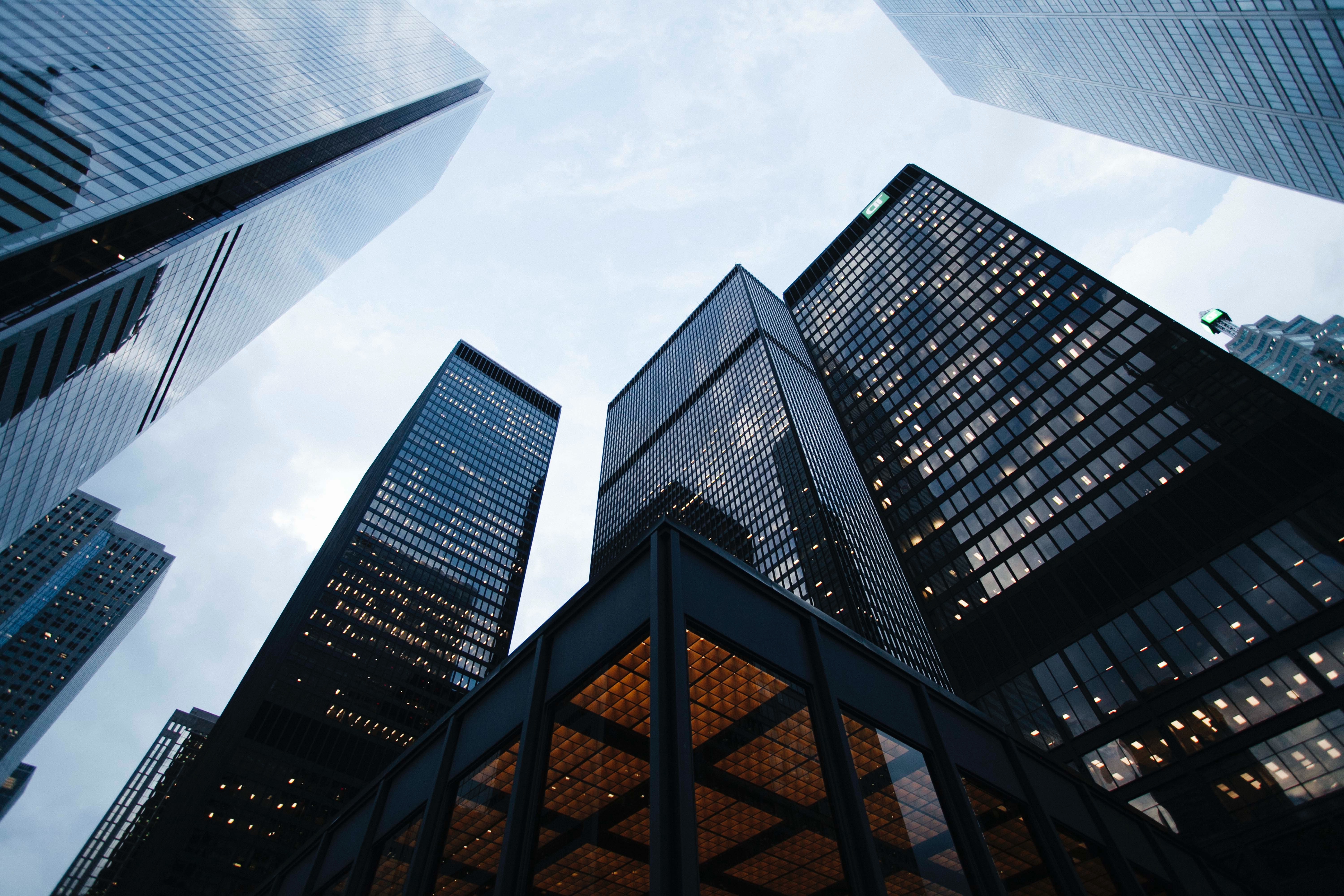 low angle photo of city high rise buildings during daytime