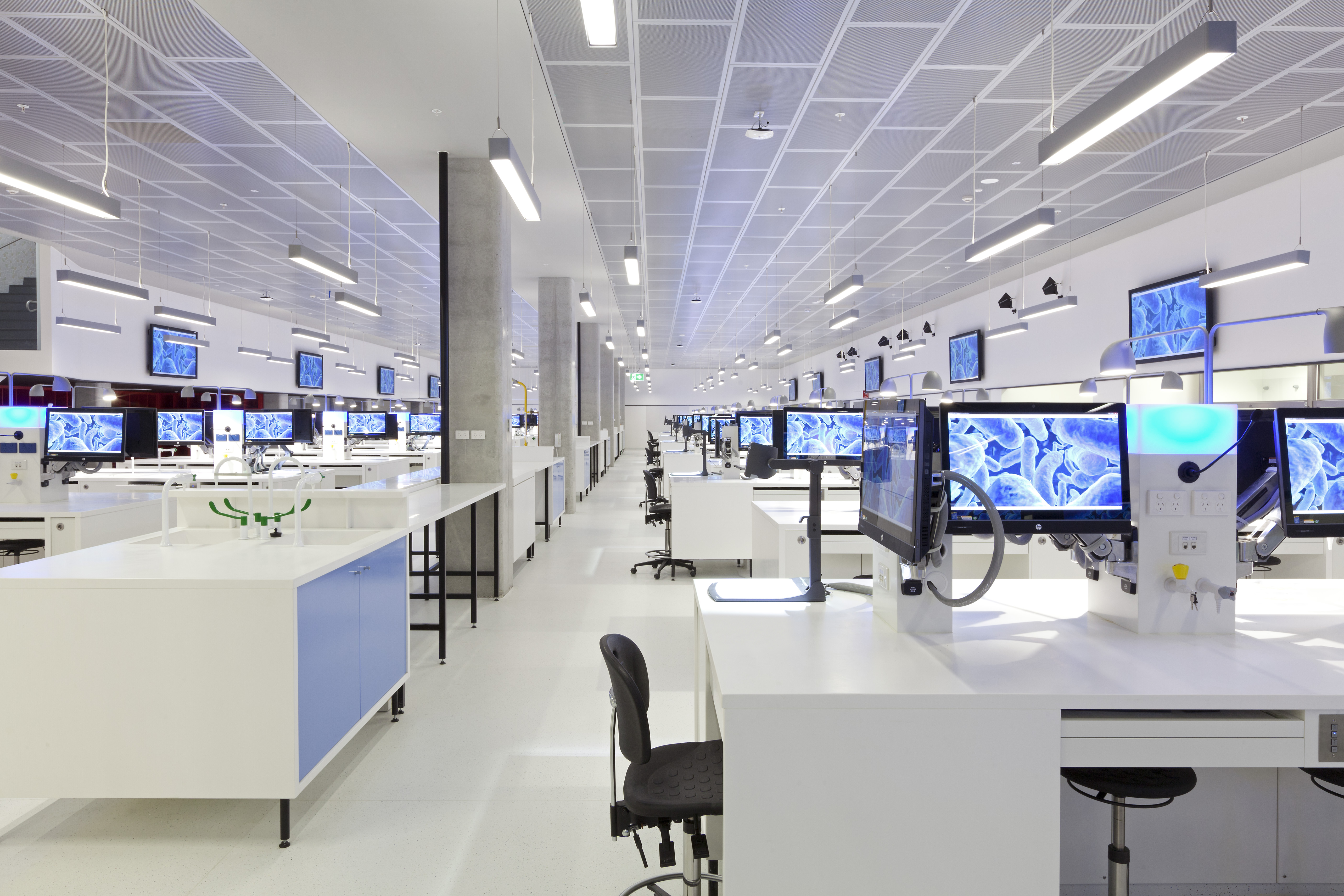 Large open room with workbenches, chairs, computers.