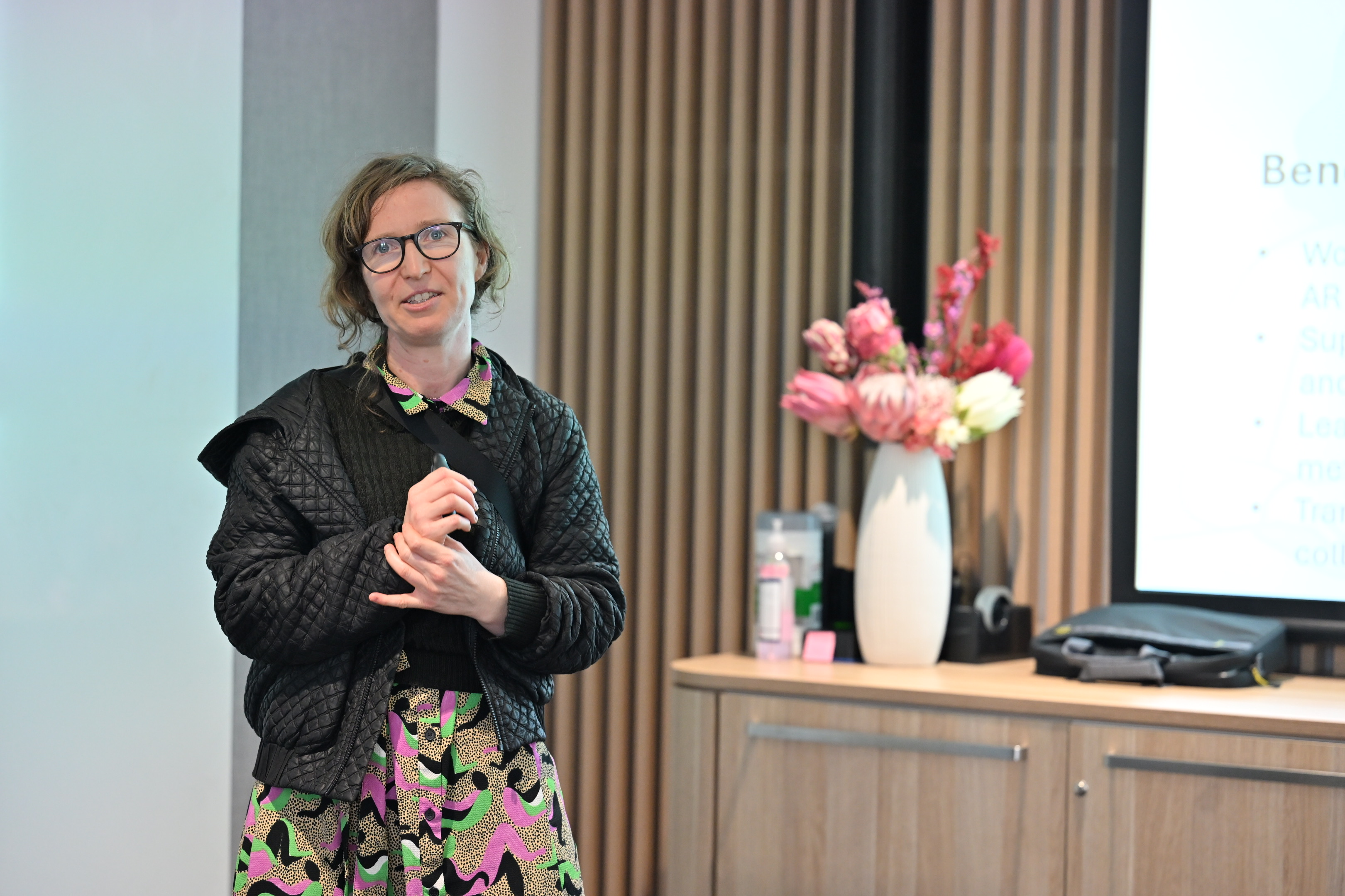 Susie speaking in front of screen