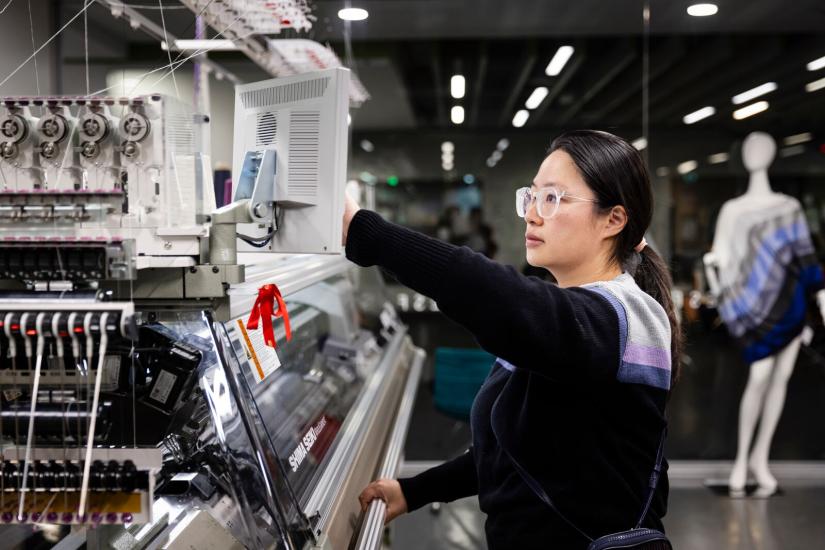 Technical Expert Shirley Tam using the Shima Seiki WHOLEGARMENT knit machine