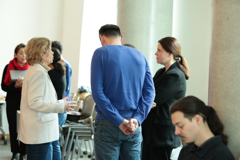 people talking at the Research Cafe and a man seated